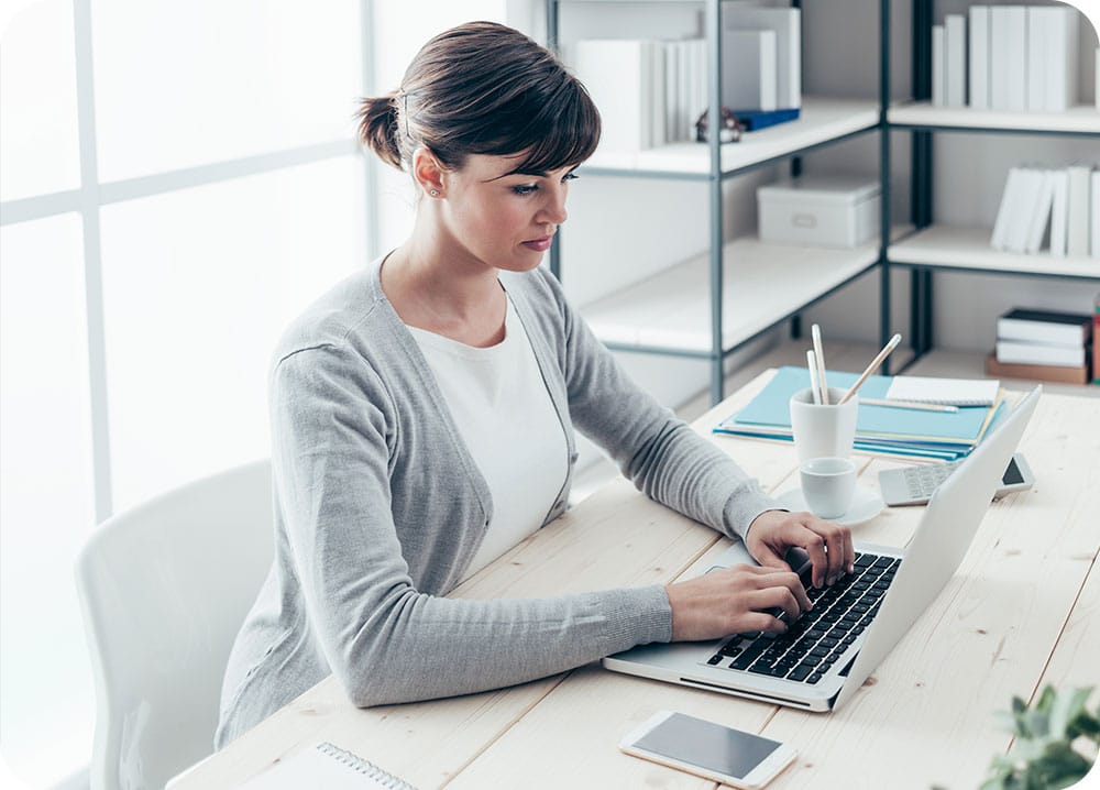 receptionist sending message to patient from laptop