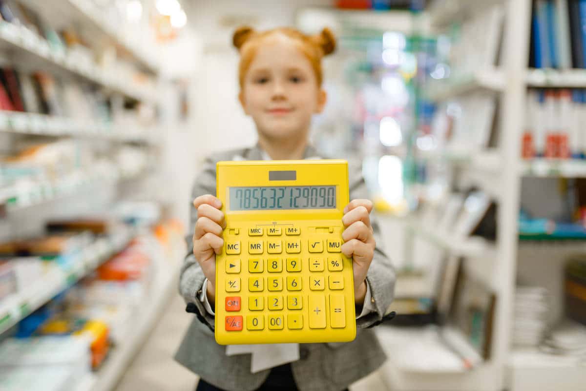 School girl with calculator, stationery store