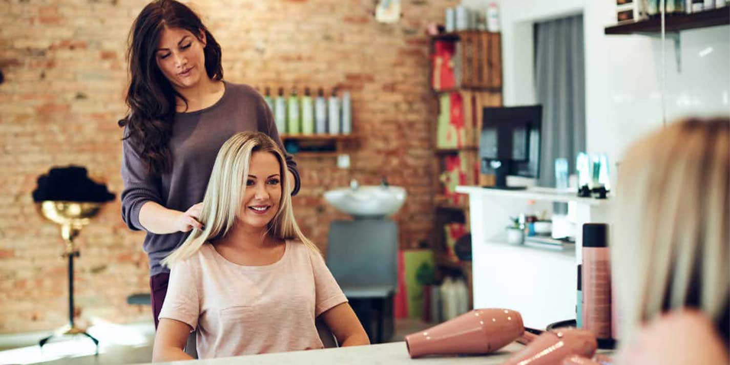 rsz_smiling-woman-discussing-her-hair-with-a-salon-hwgjfy3