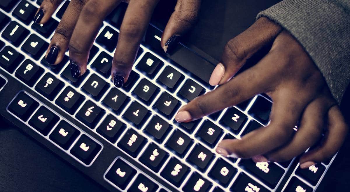 Closeup of hands working on computer keyboard